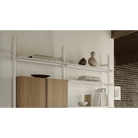 Modern interior with a white shelf unit and wooden cabinet.